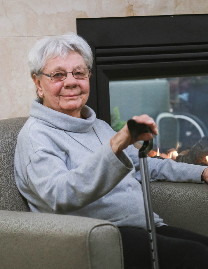 Mary Ellen Carlson sitting by fire