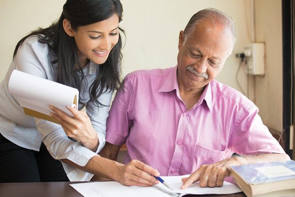 Caregiver helping patient with paperwork