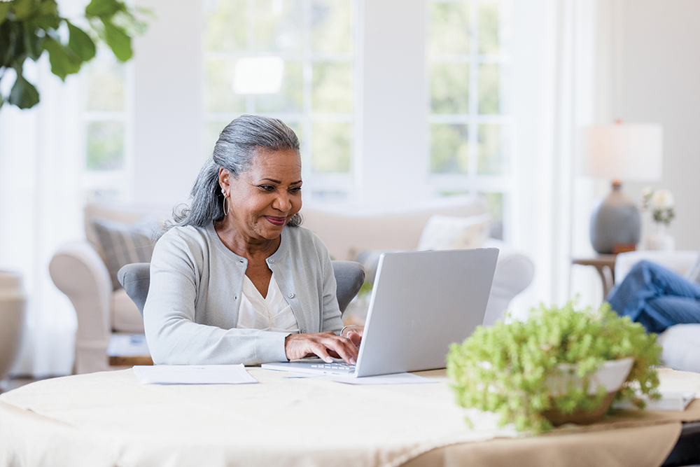 Woman at computer smiling.