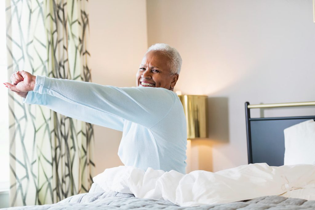 Woman stretches after waking up.